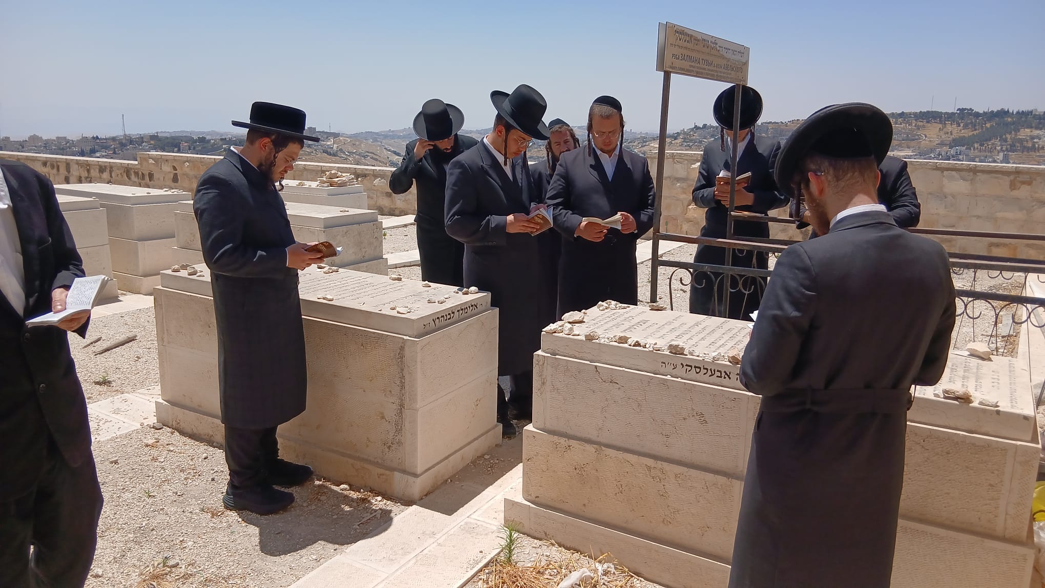 Ten men reciting Kaddish at gravesite in Jerusalem cemetery